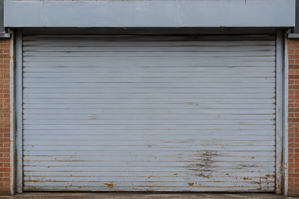 Commercial roller shutter door before painting in Milton Keynes
