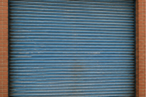 Faded roller shutter door before repainting in Milton Keynes