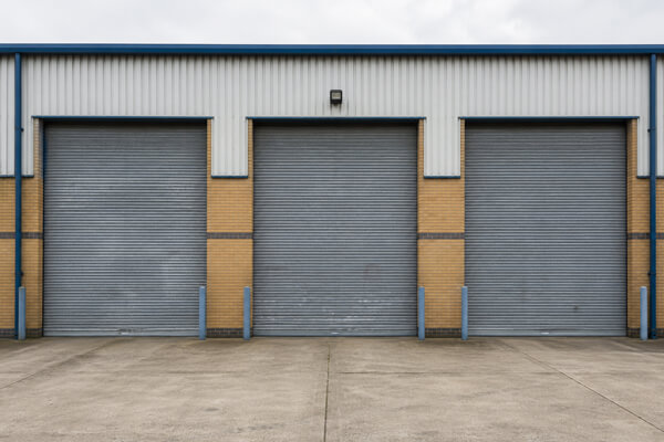 Multiple roller shutter doors before painting in Hatfield