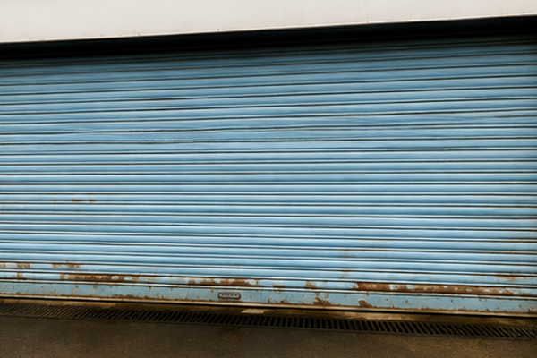 Warehouse roller shutter door before painting in Hatfield